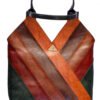 Artisan leather tote bag with a unique geometric design featuring diagonal stripes in deep green, warm orange, and rich burgundy. This stylish handbag includes a sturdy black handle and a gold triangular emblem, perfect for eco-conscious fashion lovers seeking a statement accessory.